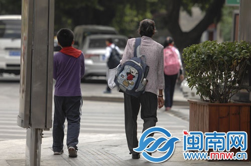 奶奶帮孙子背着书包