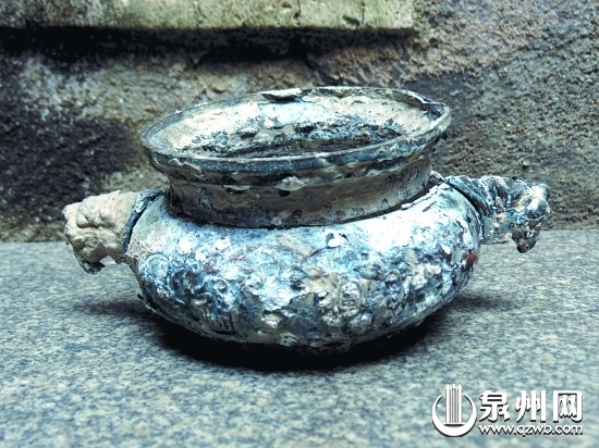 考古发现的龙头青铜香炉已与海蛎壳融合在一起