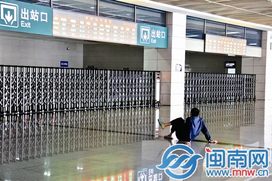 候客大厅没有座位，一位长期等待的市民席地而坐