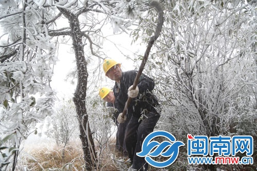 电力员工清理巡视通道上的覆冰