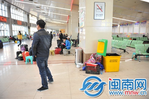 客运中心站二楼墙角垃圾桶处，杂物乱堆，垃圾未入桶