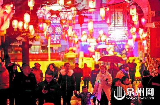 昨日在市区后城旅游文化街，市民在雨中赏花灯