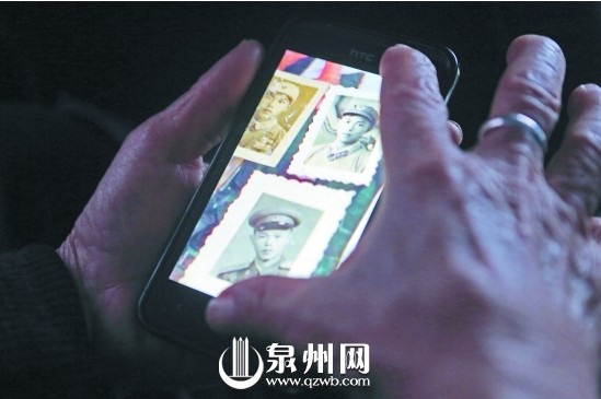杜德谋老人不时拿起手机，看看洪松柏当年的照