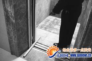 李先生拿了木棍把电梯定住