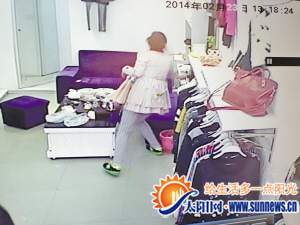 两人拖住店主，另一人趁机偷手机