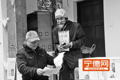 傅喜文在给游客展示他的个人经历。