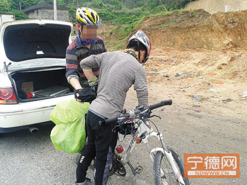 到达盐田,大学生从警车上搬下自行车