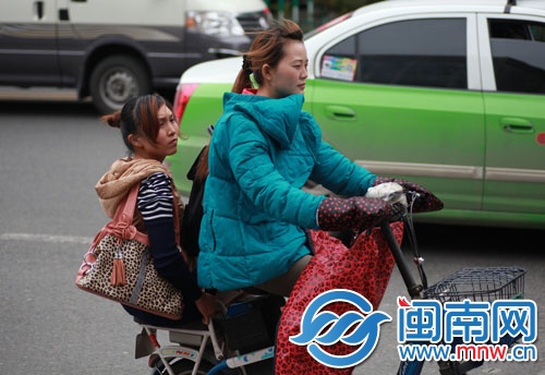 气温不高，有行人穿着厚衣