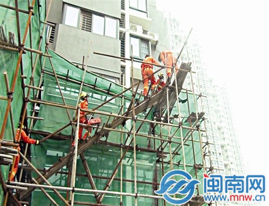消防人员在脚手架上实施救援