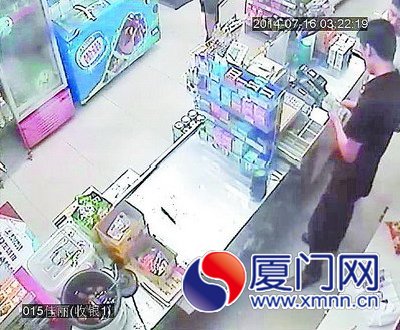 一名男子从收银机里拿钱